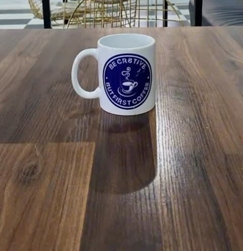 Cr8tive mug reading “Be Cr8tive, but first coffee” on a wooden table