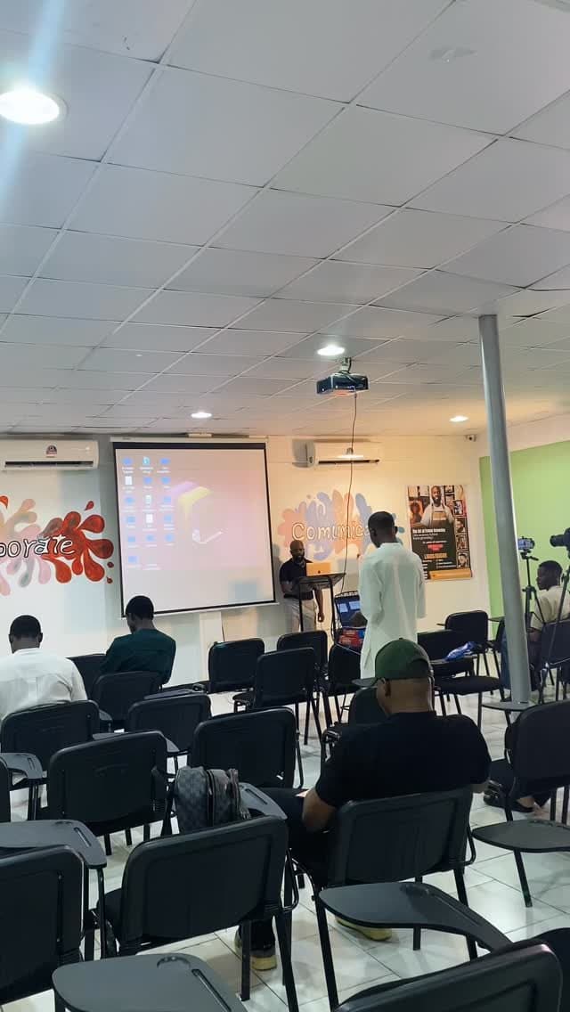 Training session in progress with an audience facing a projected presentation